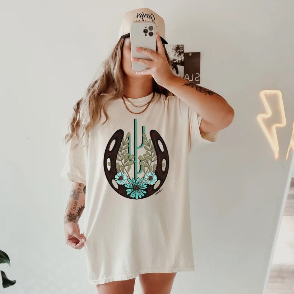 Turquoise Horseshoe Cactus Floral Graphic on Gildan Softstyle Natural Shirt – Graphic Tee, Long Sleeve & Crewneck.